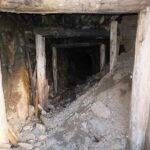 Entrance of an old obsolete and partially colapsed mining shaft.