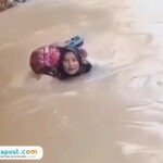 Bidan di Sumbar sebrangi sungai (Sumber: tangkap layar medsos)