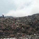 Foto : Terlihat dari kejauhan dua petugas pemadam kebakaran berjibaku memadamkan api di TPS Plosojenar Pati. (Sumber. Mitrapost.com/ Ilham) TPS Plosojenar Jakenan